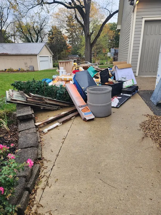 Dumpster being loaded with debris for 12 Yard Dumpster Rental in Tallmadge